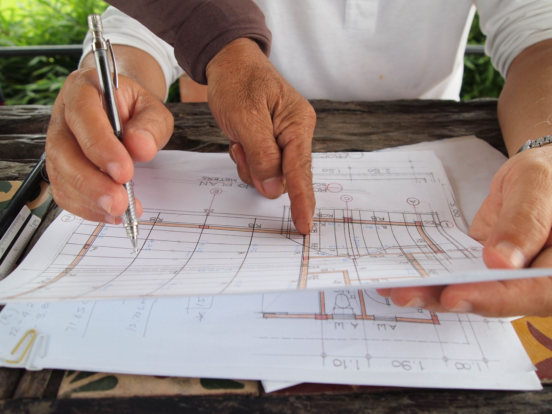 Two people reviewing a detailed architectural plan together